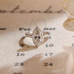 a close up of a ring on top of a piece of paper with numbers in the background