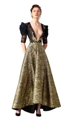 Get glam in this red carpet evening gown by Edward Arsouni Couture. The magnificent bodice has a dramatically plunging v-neckline and luscious lace elbow length sleeves with sophisticated pleated accents. This memorable ensemble sparkles with gilded adornments and shimmers to the long high-low silhouette hem in rich, paisley patterned waves.  #eveninggown #couture #fashion #womensfashion #blacktie Formal V-neck Gown With Sheer Bodice, Luxury Fitted V-neck Gown, Elegant Fitted V-neck Ball Gown, Luxury V-neck Gown For Prom Season, Couture Evening Dress With Sheer Bodice, Couture Formal Evening Dress With Sheer Bodice, Couture Evening Dress With Sheer Bodice For Gala, Couture Evening Dress With Sheer Bodice For Formal Events, Glamorous V-neck Cocktail Gown