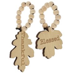 two wooden beads with words on them are attached to the ends of each bead