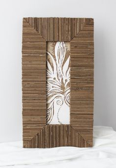 a photo frame made out of bamboo sticks with an intricate design on the front and sides