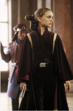 a woman in a star wars outfit standing next to a man