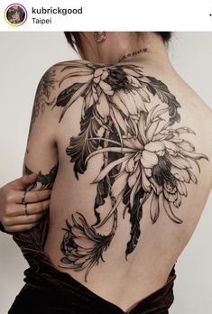 the back of a woman's body with flowers on it