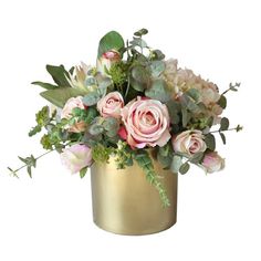 a gold vase filled with pink flowers and greenery