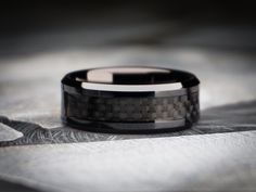 a wedding band that is black and grey