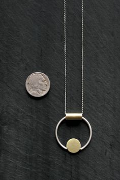 "PETITE ELORIA - By L.Greenwalt Jewelry Featured: Formed and soldered brass and sterling silver pendant on a sterling silver chain, also available in all brass. Tube / bale is not fixed allowing abstract movement of pendant. Pendant measures approximately 1.25\" in diameter. You choice of sterling silver chain or brass chain, 16.5\" or 28\". Always, all items come in a branded L.Greenwalt Jewelry box for whatever your occasion may be. Thank you so much for checking it out! L.Greenwalt Jewelry Co Architectural Jewelry, Fan Necklace, Rainbow Necklace, Small Circle, Geometric Circle, Message Jewelry, Geometric Necklace, Circle Necklace, Silver Pendants