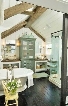 a bathroom with a claw foot tub, sink and shower in the middle of it