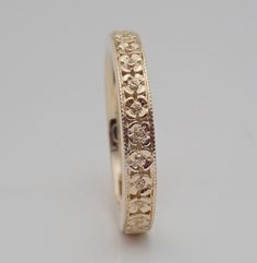 "This flower wedding band can made in 14k and 18k yellow, white and rose gold. The Band is hand carved, migrained and high polished. This band is approximately 3 mm wide and 1.7 mm average thickness 1.7. We can make it any size from 5 to 7 and you still be able to return it within the listed time frame. Email for pricing on sizes under 5 and sizes over 7. Available in 18K gold and platinum. Email for 18k gold platinum pricing. We love this ring because it represents the way jewelry should be mad 14k Gold Wedding Bands Fine Jewelry, Heirloom 14k Stamped Round Wedding Ring, Gold Wedding Band Stamped 14k, Gold Stamped 14k Round Wedding Band, Elegant 14k Stamped Bands For Anniversary, Yellow Gold 14k Stamped Jewelry For Marriage, Stamped 14k Round Band For Anniversary, Elegant Jewelry With Decorative Band For Marriage, Elegant Marriage Jewelry With Decorative Band