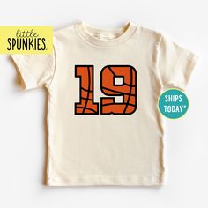 Retro Player Numbers Shirt, Custom Basketball Natural Graphic Tee, Cute Basketball Gift (BASKETBALL NUMBERS) PRODUCTION TIME Little Spunkies from the designer/owner of Spunky Pineapple Co https://www.etsy.com/shop/SpunkyPineappleCo   All baby and toddler clothes are 100% designed and printed with water based ink. All orders placed before 12:00 pm EST are shipped out same day (Monday - Friday). Orders received after noon are shipped out the next business day. ONESIES® BRAND Made from 100% Cotton. We print on Onesies® Brand. T-SHIRT Made from 100% Cotton. These run true to size. If you are in between sizes we suggest sizing up. CARE Machine wash in cold water, inside out, and tumble dry.   SHIPPING All orders are shipped out via USPS First Class Mail (3-4 days).   Shipping upgrades are avail Basketball Numbers, Toddler Basketball, Number Shirt, Basketball Tees, Basketball Gifts, Custom Basketball, Kids Graphic Tees, Baby And Toddler, Toddler Clothes