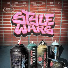 graffiti spray paint cans in front of a brick wall with the word sale wars written on it