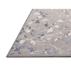 a gray rug with blue and white flowers on it