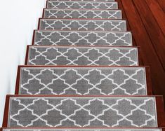 a set of gray and white carpeted stairs