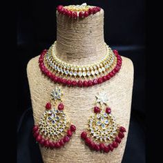 Gold Rodium Polish Red and Maroon color Necklace in Metal Alloy studded with CZ Diamond, Kundan Red Metal Choker Jewelry, Red Round Jewelry For Festivals, Festive Red Metal Jewelry, Red Beaded Kundan Necklace For Gift, Red Metal Necklaces With Jewels, Red Jeweled Metal Necklaces, Red Stone Jewelry For Celebration, Red Ruby Choker Jewelry, Red Ruby Choker Necklace