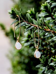 These streamlined earrings feature Druzy Teardrops in a gorgeous shade of white, secured in my original bezel wrapped style in your choice of metal, suspended from handmade ear wires hammered and formed into a modern almond shape. The finished product is a long linear earring that is super unique also light weight and comfy enough that you could forget you're wearing them. The shape of these ear wires is an intentional design meant to keep these earrings in place, and it works beautifully. This White Teardrop Pendant Jewelry With Matching Earrings, Adjustable Teardrop Crystal Earrings With Ear Wire, White Teardrop Linear Earrings Dainty Style, White Teardrop Wire Wrapped Earrings, White Teardrop Dainty Linear Earrings, White Dainty Teardrop Linear Earrings, Dainty White Teardrop Linear Earrings, Adjustable White Teardrop Dangle Earrings, Everyday Adjustable Teardrop Linear Earrings