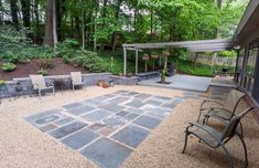 an outdoor patio with stone pavers and seating area