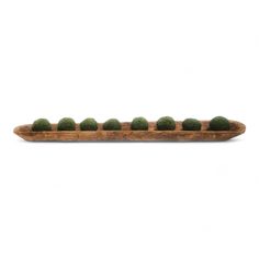 a wooden tray filled with green balls on top of it