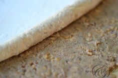 an uncooked pizza crust sitting on top of a table