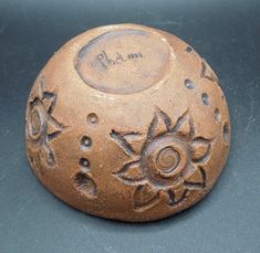 a brown object with designs on it sitting on a table