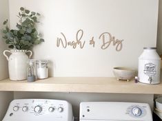 a washer and dryer sitting on top of a shelf in a laundry room