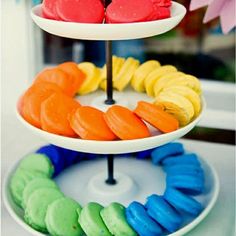 three tiered trays filled with different colored pastries