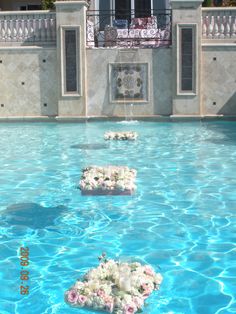 the pool is decorated with flowers and candles