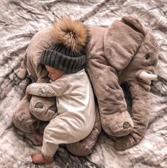 a baby is laying down with an elephant stuffed animal on it's back and the caption reads instagram