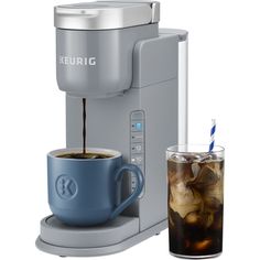 a cup of coffee is being filled with ice and water next to a keurig machine