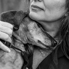 a woman holding a dog in her arms