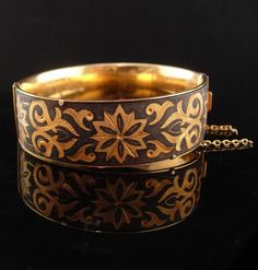 "This is a victorian hollow bangle bracelet that is made with the damascene symbols .  The bracelet is 6 3/4\" long on the inside of the bracelet when closed and is 1\" wide.   This bracelet has a safety chain too . It is well made, has been well taken care of and is an amazing piece in great condition.   1-2-21" Victorian Bracelet, Antique Bracelets, Vintage Bangles, Safety Chain, It Is Well, Victorian Jewelry, Vintage Santas, Moscow Mule Mugs, Cute Bag