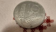 a silver coin sitting on top of a white cloth