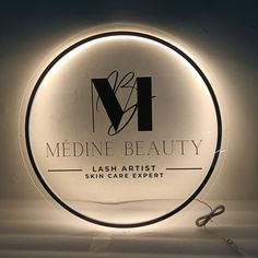 a lighted sign that says medine beauty with scissors in front of it and the words, flash artist skin care expert