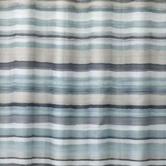 a shower curtain with blue and white stripes on it