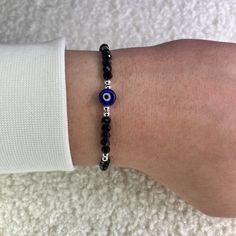 Protect yourself from negativity with our black evil eye bead bracelet with silver balls and bring only positive vibes into your life. Since all of our Nazar protective bracelets with the popular Turkish eye are adjustable in size, they fit children, women and men and are therefore the perfect gift. What are the advantages of our 100% handmade black protective amulet? ❤️ Unique Hamsa or Boncuk design. ❤️ Uniquely braided and therefore suitable for every wrist. ❤️ Many color variations and therefore suitable for every outfit. How does it protect children, women and men? 🧿 Built-in Nazar amulet in the style of the Greek eye. 🧿 Reflective crystal balls in a bling bling look. 🧿 Daily reminder to manifest positive things for yourself. What materials are used? 💎 Polyester for a comfortable w Protective Bracelets, Black Evil Eye Bracelet, Only Positive Vibes, Evil Eye Bracelet Silver, Nazar Bracelet, Nazar Amulet, Black Evil Eye, Eye Bead Bracelet, Protective Amulet