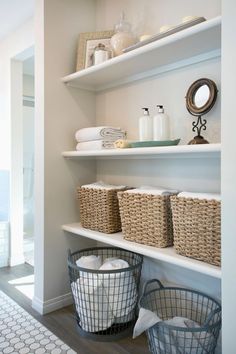 the shelves in this bathroom are filled with baskets