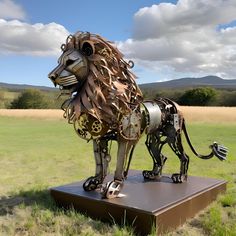 a metal lion sculpture sitting on top of a field