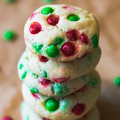 three cookies stacked on top of each other with green and red sprinkles