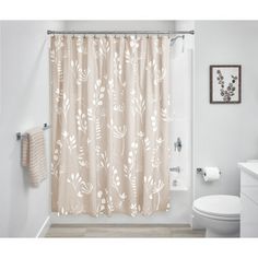 a bathroom with a shower curtain and toilet