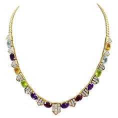 Fashion Forward 18 Karat Yellow Gold Colored Stone Necklace Featuring 94 Round Brilliant Cut Diamonds of VS Clarity and G/H Color Totaling Approximately 2.00 Carats Accented By 12 Oval Citrine, Garnet, Amethyst, Peridot, and Blue Topaz. Curb Link Chain at Back with Box Clasp and Figure 8 Safety. 15.75 Inches Long. Finished Weight Is 37.0 Grams. Formal Multicolor Gemstone Necklaces, Formal Multicolor Diamond Gemstones, Luxury Multicolor Necklace With Gemstone Accents, Luxury Multicolor Necklaces With Gemstone Accents, Luxury Multicolor Gemstone Necklaces, Luxury Multicolor Multi-stone Necklaces, Luxury Multicolor Necklaces For Anniversary, Luxury Multicolor Necklace For Formal Occasions, Multicolor Necklaces With Gemstone Accents For Formal Occasions