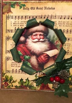 an old fashioned christmas card with santa holding a piece of paper and holly wreath on it