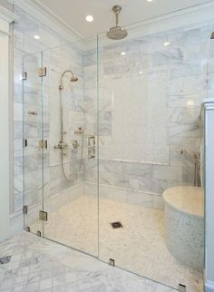 a walk in shower sitting inside of a bathroom