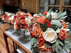 several vases filled with flowers on top of a table