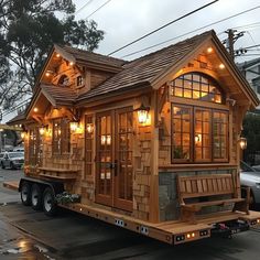 a small wooden house is on the back of a truck