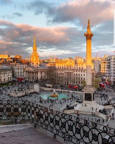 the city is full of people and buildings, including two large towers with golden spires