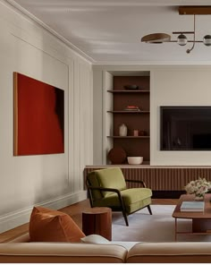 a living room filled with furniture and a flat screen tv mounted to the side of a wall