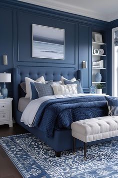 a bedroom with blue walls and white furniture