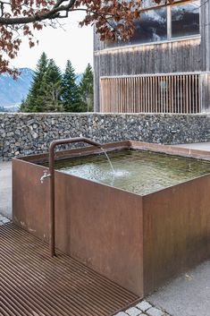 an outdoor hot tub with water coming out of it