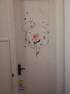 an open door with a drawing on the front and side of it that has a red rose in its mouth