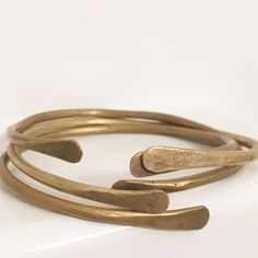 "Hand-forged brass bangle bracelet. SKINNY BRASS BANGLE BRACELET: These bangles may be hand-forged from brass, but we think they're fashion gold! 😜 Delicate and minimalist, these are perfect as a stand-alone bracelet or for stacking multiples. Handcrafted from 1/8\" thick brass, what sets our bracelets apart is that these are hand-forged from raw brass rather than cheap factory blanks. Each bangle is heated and hammered out on a blacksmith's anvil to give it our signature flared ends and eye-ca Stacking Bangles, Hammered Bracelet, Bracelet Stacking, Brass Bangle, Brass Bracelet, Stacked Bangles, Signature Jewelry, Gold Fashion, Raw Brass