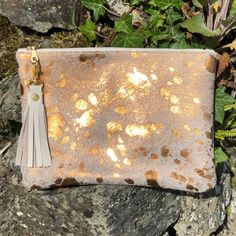 This Breccia clutch is a beautiful bag that is great for so many occasions, or for use everyday with style! Dimensions: Height: 18cm (7.08in) Width: 24cm (9.4in) Flat construction It is made from hair on cowhide in metallic bronze on the front with soft, cream leather on the back or you can choose cowhide on both sides - please see the Material options below.  The Breccia has a cotton, light fawn lining with gold stars and a handy credit card sized pocket inside. It has  a pretty YKK gold colour Cowhide Clutch, Gold Clutch Bag, Gold Clutch, Gold Bag, Gold Leather, Gold Stars, Beautiful Bags, Inside Pocket, Evening Bags