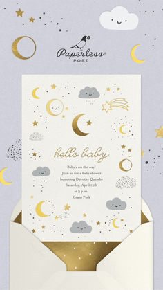 a white envelope with gold foil stars and clouds