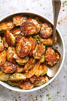 a white bowl filled with cooked brussel sprouts